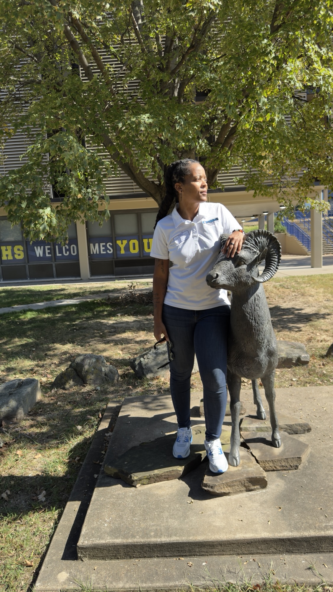Mahogany Henderson, founder of Most Precious Dreams Foundation, standing beside the Riverview Rams statue at Riverview Gardens High School in St. Louis, Missouri.